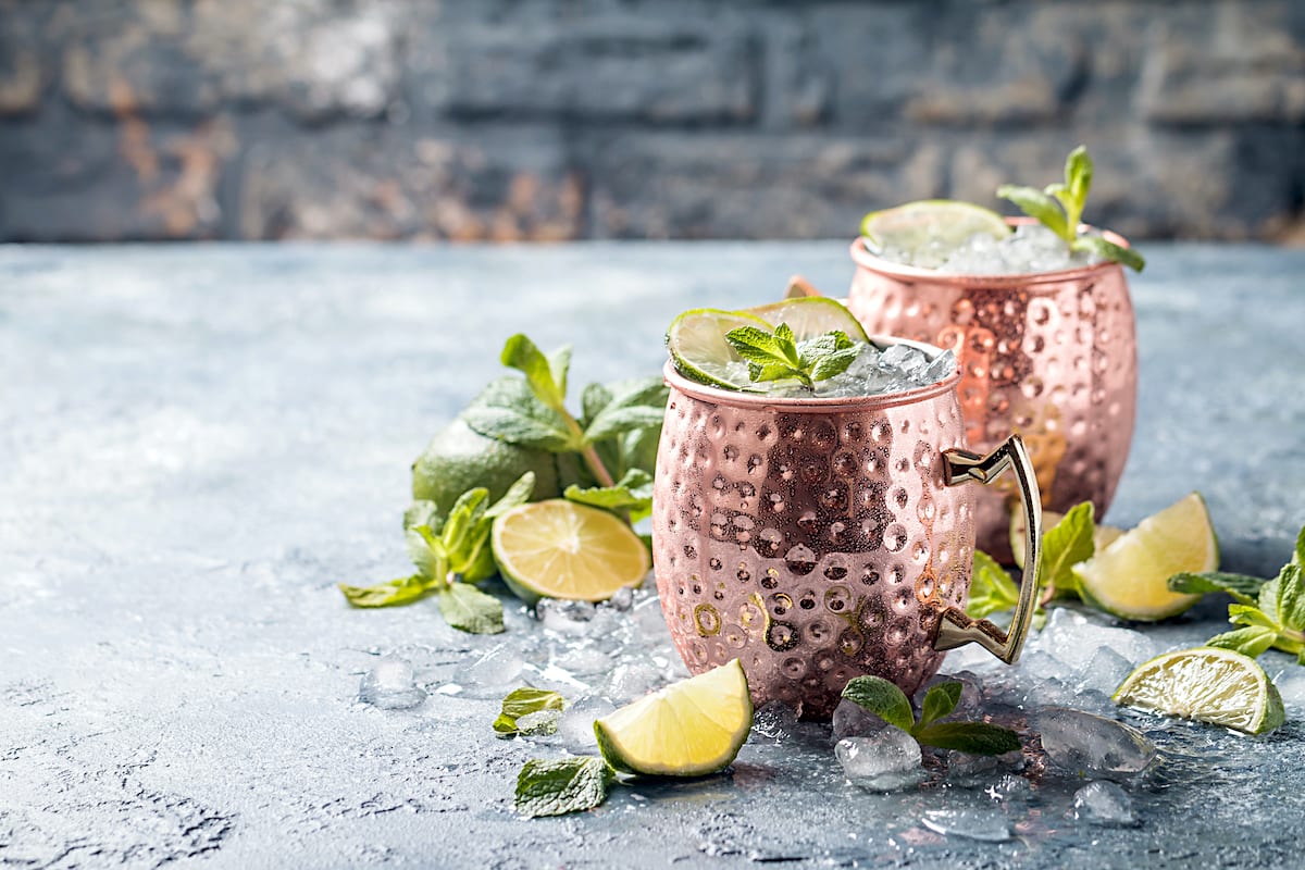 Moscow-mule-cocktail in copper mug garnished with lime and mint